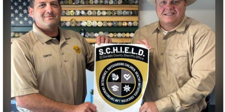 Deputy Aaron Campora and Sheriff Jeff Leikauf show off the emblem for SCHIELD